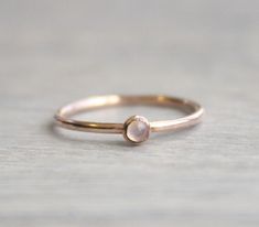 Beautiful birthstone stacking rings. Made in 14k rose gold filled and stone is a 3mm genuine rainbow moonstone. This ring is made to order in your size. If you don't see your size available please feel free to message me. All orders ship in a gift box. If you are ordering multiple items and want them boxed separately, please let me know in the notes at checkout. I ship via USPS. Please review the estimated delivery date and processing times. Processing times vary based on how busy my shop is at Dainty Rose Gold Moonstone Ring Gift, Delicate Rose Gold Moonstone Ring, Dainty Rose Gold Moonstone Ring, Delicate Rose Gold Moonstone Birthstone Ring, Delicate Rose Gold Moonstone Ring With Birthstone, Dainty Rose Gold Stackable Rings With Gemstones, Minimalist Rose Gold Moonstone Ring As Gift, Minimalist Rose Gold Moonstone Promise Ring, Rose Gold Moonstone Birthstone Ring