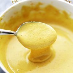 a spoon full of honey mustard sauce in a white bowl with the title homemade honey mustard sauce