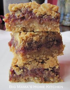 three bars stacked on top of each other with crumbled toppings in the middle