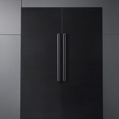 a black refrigerator freezer sitting inside of a kitchen