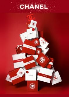 a christmas tree made out of red and white boxes with the word chanel on it