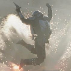 a person in the air on a snowboard with fireworks coming out of their feet