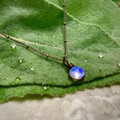 "The Morning Dew Drop Necklace is inspired by the beauty of nature. It has the perfect Summer Aesthetic that goes with everything. It is one of the smallest pendants that I make. The glass used is Crystal Clear with a dichroic glass with a delicate iridescence that changes in color. The sparkle is subtle and simple and changes depending on the lighting and the colors behind the glass. This is a great size for everyday wear or to layer with other designs. Chains: Cable Chain and Satellite Chain. Adjustable Minimalist Teardrop Pendant Charm Necklaces, Minimalist Water Drop Jewelry For Gifts, Minimalist Water Drop Jewelry As Gift, Minimalist Water Drop Jewelry Gift, Dainty Moonstone Charm Necklace For Gift, Minimalist Water Drop Jewelry For Everyday, Minimalist Wire Wrapped Necklace For Gifts, Minimalist Wire Wrapped Charm Necklaces As Gift, Minimalist Wire Wrapped Charm Necklace For Gift