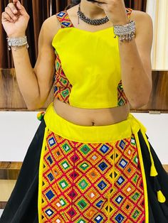 Celebrate the vibrant and joyous festival of Navratri in style with our exquisite Black & Yellow Navratri Lehenga Choli. This stunning ensemble is specially designed to make you feel comfortable and look absolutely stunning throughout the festivities.
Crafted with a beautiful blend of cotton silk, our lehenga brings together the best of both worlds – the comfort of cotton and the elegance of silk. The choli, made from pure cotton, perfectly complements the beauty of the lehenga with its vibr Festival Choli With Gota Work And Traditional Drape, Navratri Festival Dress With Gota Work, Bohemian Sets With Gota Work For Navratri, Bollywood Style Multicolor Saree Skirt Set, Navratri Festival Sets With Zari Work, Diwali Festival Dress With Gota Work, Black Bohemian Choli With Pallu, Multicolor Skirt Set For Party And Festivals, Multicolor Party Skirt Set For Festivals