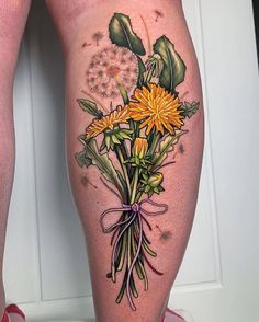 a woman's legs with flowers and leaves on them