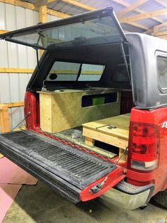 the back end of a pickup truck with its cargo compartment open and it's bed opened