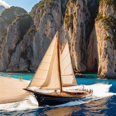 a sailboat is sailing on the water in front of some rocky mountains and cliffs