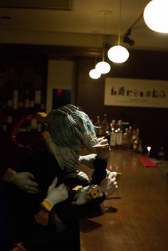 two mannequins are sitting on the bar counter