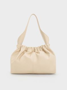 This iteration of our Ally bag is definitely not to be missed. It features a bigger and slouchier silhouette that offers ample space to hold everything you need in a day and more. In an soft neutral beige, this bag will create a lovely contrast with your dark-toned ensembles. To top it off, it will match well with most of the pieces in your existing wardrobe, making it a versatile style staple that you will reach for again and again. Slouchy Bag, Slingback Flats, Size Chart For Kids, Consumer Protection, Charles Keith, Neutral Beige, Belt Size, Bag Straps, Large Bags