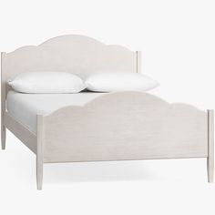 a bed with white linens and pillows on it's headboard, in front of a white background