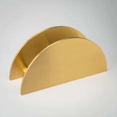 a gold metal object on a white surface with no one around it or in the background