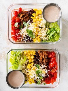 two plastic containers filled with salad and dressing