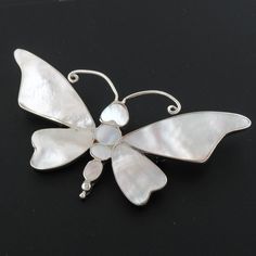 "925 Sterling Silver White Genuine Oyster Mother Of Pearl Shell Butterfly Brooche Pendant  This adorable butterfly style pendant is designed in genuine iridescent white mother of pearl shell, generously set and backed in 925 sterling silver.  Broche Material:  Solid 925 sterling silver Broche Size:  70x50mm(2 7/8\"x2\") Shell Type:  White mother of pearl Total Weight:  12.9 grams" White Sterling Silver Brooches For Wedding, White Anniversary Brooch Jewelry, White Sterling Silver Wedding Brooches, White Butterfly Charm Jewelry For Anniversary, White Sterling Silver Brooches As Gift, White Hallmarked Brooches As Gift, White Brooch Jewelry Gift, White Pendant Brooch Gift, White Butterfly Brooches For Gifts