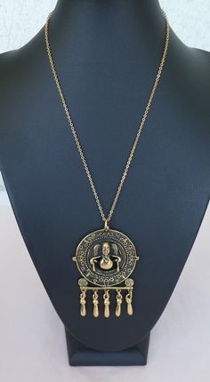 Here we have a superb French vintage modernist gilded bronze pendant by Paris designer Marcel Buffet which features an ethnic indian inspired design. Circa 1970's, made in France. Stamped M. Buffet on the back of the pendant. Chain not included. Looks stunning worn as a pendant with a gold chain or a fine leather cord.  In excellent condition. Comes in a small gift box.  Measures - 6.2cms x 4.2cms /2.5ins x 1.6ins.  Please remember that these are vintage items and they have been preloved, so they may have small imperfections (which I do my best to show in the photos).  Any small difference in colour is due to my camera and difference between indoor and outdoor light. Items come from a smoke free and pet free environment. Please do not hesitate to get in touch if you have any question. Plea Bohemian Gold Medallion Necklace In Brass, Gold Medallion Necklace For Festival, Gold Medallion Necklace For Festivals, Brass Temple Necklace With Antique Finish, Gold Brass Temple Necklace With Antique Finish, Vintage Gold Brass Temple Necklace, Vintage Brass Temple Necklace For Festivals, Gold Temple Necklace For Festivals, Golden Pendant