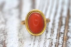 Amazing Statement ring. 18k yellow gold set with a Deep Orange CORAL cabochon gem. The Coral is very large. It is overall a stunning piece. Condition: Shows little signs of wear. Details: 10mm by 14mm orange Coral 8mm rise off finger 4.6grams total weight 14k Gold Dome Ring With Oval Cabochon, Formal Oval Jewelry With Fluted Bezel, Elegant Oval Signet Ring With Cabochon, Gold Oval Ring With Fluted Bezel, Oval Dome Ring With Smooth Bezel For Gift, Classic Oval Cabochon Ring With Smooth Bezel, Oval Dome Ring With Smooth Bezel As Gift, Oval Dome Ring With Bezel Setting For Gift, Oval Dome Ring With Bezel Setting