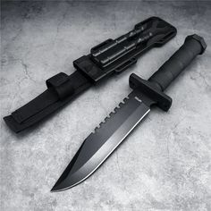 two knives are laying next to each other on the ground, one has a black handle