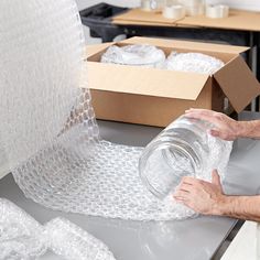 a man is wrapping up some items on a table