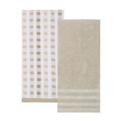 two towels in beige and white with brown dots on them, one is folded over the other