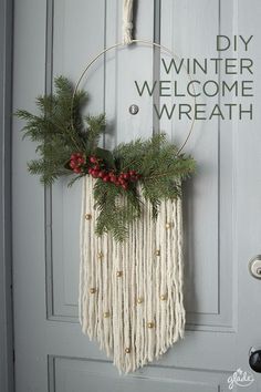 a christmas wreath hanging on a door with the words, diy winter welcome wreath