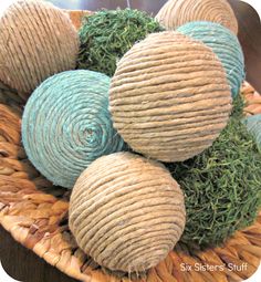 several balls of yarn sitting in a woven basket