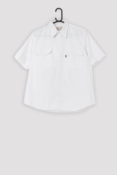 Vintage Levis Sta-Prest shirt in white. This 90s (1999) white Sta-Prest Levis shirt features a white button closure, two chest pockets with white button closures, and a black Levis tab on the left chest pocket.  Made from a mid-weight cotton blend.   Our recommended size: Medium Label says: Medium Condition: Very good Material: 60% cotton, 40% polyester Measurements in inches, laid flat: Pit to pit: 22.5 Shoulders: 17 Front length: 27 Back length: 28 Sleeve length: 10 We recommend that you compa Levis Shirt, Black Levis, Vintage Levis, Chest Pocket, Levi's, Tee Shirts, Bathing Beauties, Cotton Blend, Mens Shirts