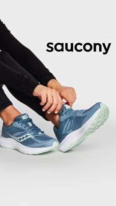 a woman tying her shoes with the saucony logo