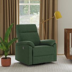 a green recliner chair sitting in front of a window next to a baby crib