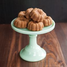 a green cake plate with bundt cakes on it