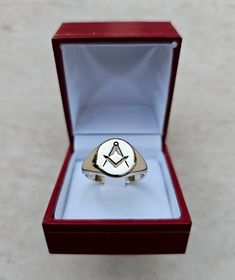 Square and Compass Masonic Ring, made out of 9K Gold, classic chevalier design that bares the motife of the Order. Due to its simplicity, it's ideal for the small finger. Available in large quantities other metals and other stones upon request.  Box dimensions of 45 Χ 50 Χ 40 mm having a total weight of 45 grams.  The price DHL shipping with tracking number. Classic Yellow Gold Signet Ring With Maker's Mark, Classic Adjustable Initial Open Ring, Symbolic Formal Signet Ring Hallmarked, Symbolic Formal Signet Ring With Polished Finish, Symbolic Hallmarked Signet Ring For Formal Occasions, Formal Symbolic Hallmarked Signet Ring, Classic Formal Initial Ring With Hallmarks, Symbolic Hallmarked Initial Ring For Formal Occasions, Classic Adjustable White Gold Ring