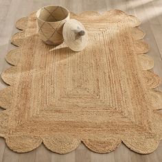 a rug with a basket on top of it and a straw hat sitting on the floor