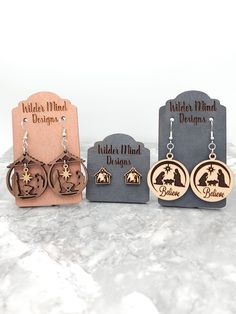 Beautiful Walnut and Maple Wood Nativity Earrings.  They are made of maple and walnut plywood, made to be stronger and more durable. These earrings are laser cut, laser engraved and are super lightweight making them easy to wear all day!  *Please Reference Size Guide Picture for sizing* Ear wires are made from surgical stainless steel. Since these earrings are handmade, I highly recommend taking them off for any water related activities such as swimming or showering and while sleeping. They come Nativity Earrings, Laser Cut Wood Projects, Laser Creations, Laser Earrings, Manger Nativity, Laser Christmas, Laser Engraved Earrings, Laser Crafts, Wood Nativity