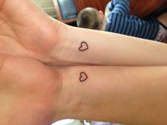 two people with matching tattoos on their wrist