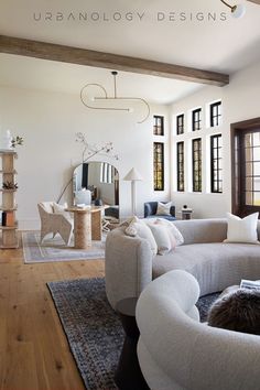 a living room filled with furniture and windows