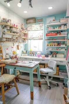 a sewing studio with lots of crafting supplies on shelves and desks in the corner