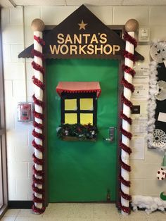 the door to santa's workshop is decorated in red, white and green