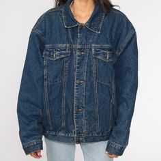 "Vintage 80s jean jacket in blue denim with a faux shearling lining. Every garment we sell is authentic vintage and one-of-a-kind! You will receive the exact item photographed. Condition: Very good vintage with light general wear. Best fits women's: Extra Large Best fits men's: large Material: denim with sherpa lining MEASUREMENTS Taken from seam to seam while the garment is lying flat. Double the armpit, waist, and hips For reference, model is 5'10\" and measures 31-23-34. Length from Top: 27\" 90s Style Oversized Denim Outerwear, Oversized 90s Denim Jacket For Streetwear, Oversized 90s Denim Outerwear, 90s Oversized Denim Outerwear, Retro Denim Blue Jacket For Winter, 90s Denim Blue Fall Outerwear, 90s Denim Outerwear In Medium Wash, 90s Style Dark Wash Denim Jacket For Winter, 90s Winter Denim Jacket For Streetwear