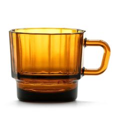 a yellow glass cup sitting on top of a table