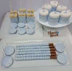 a table topped with blue and white desserts