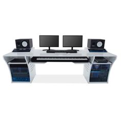 a computer desk with two monitors, keyboard and speakers on it's sides in front of a white background