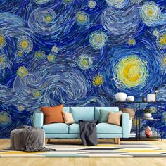 a blue couch sitting in front of a wall mural with stars and the night sky