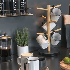 a kitchen counter with cups and mugs on it