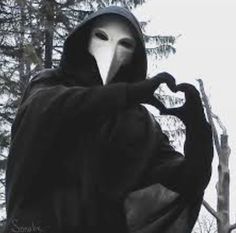 a person in a hooded jacket with a mask on their face and hands out to the side