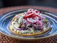 a plate that has some kind of food on it with red onions and lettuce