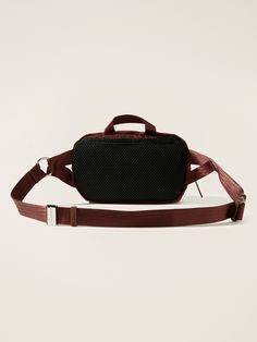 a black and brown bag with straps on it's sides, sitting against a white background