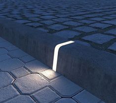 a light shines on the ground next to some bricks