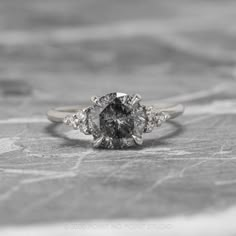 an engagement ring with three diamonds on it