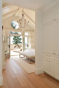 an instagram photo of a bedroom with white walls and wood floors, built in cabinets