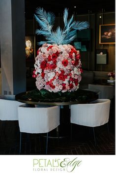 a table with chairs and a large flower arrangement on it