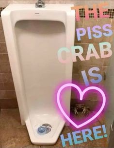 a white urinal with the words piss crab is here