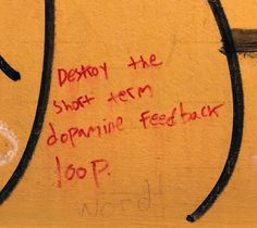 graffiti written on the side of a yellow wall with writing below it that reads destroy the short - term doppie fed back